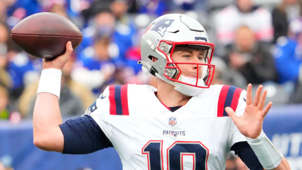 Patriots quarterback Mac Jones throws a pass during a game.